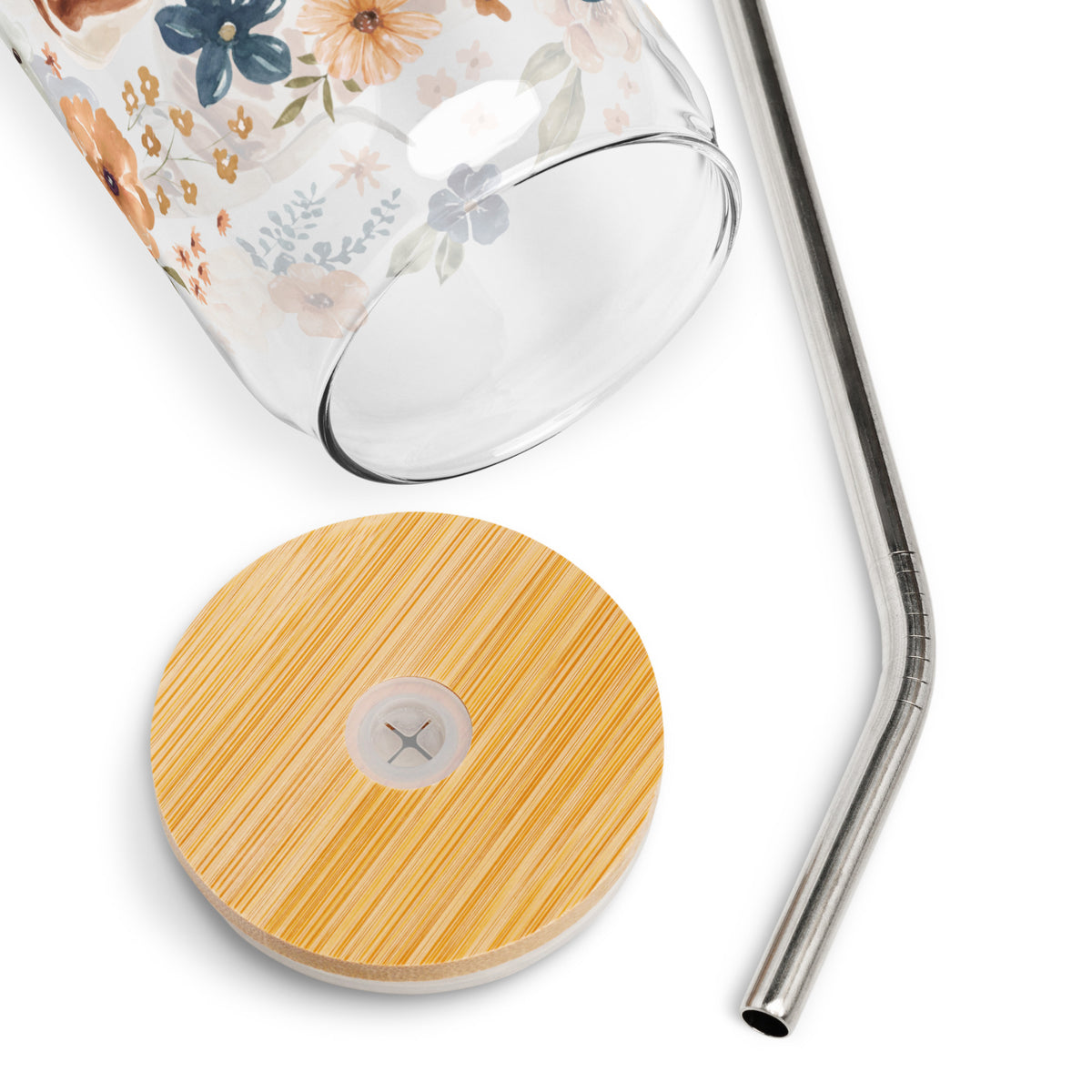 a glass with a straw and a wooden coaster next to it