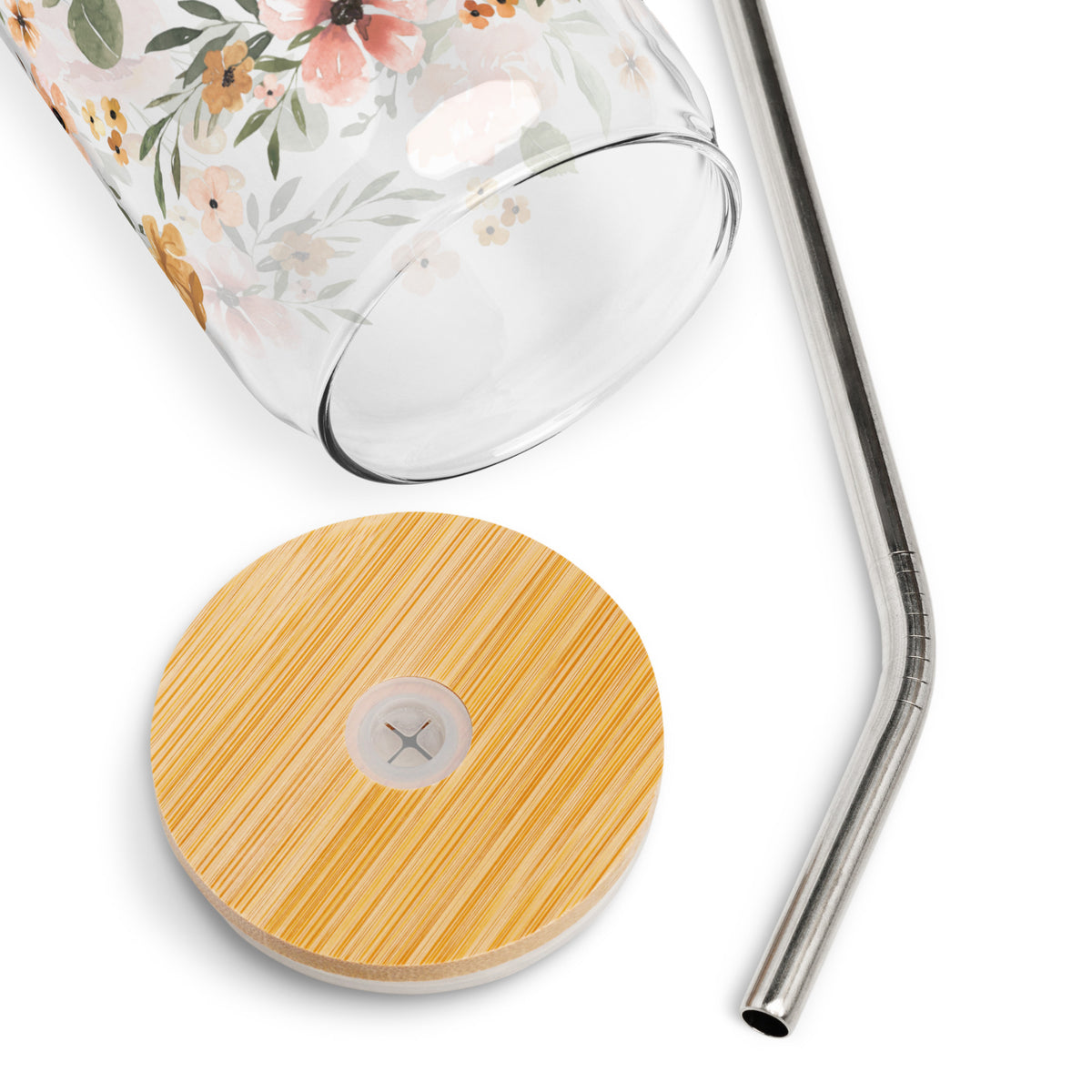 a glass with a straw and a wooden coaster next to it