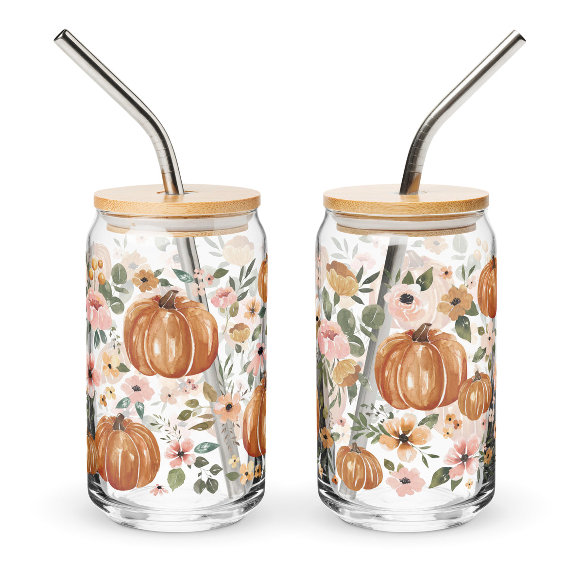 two glass jars with metal straws decorated with flowers and pumpkins