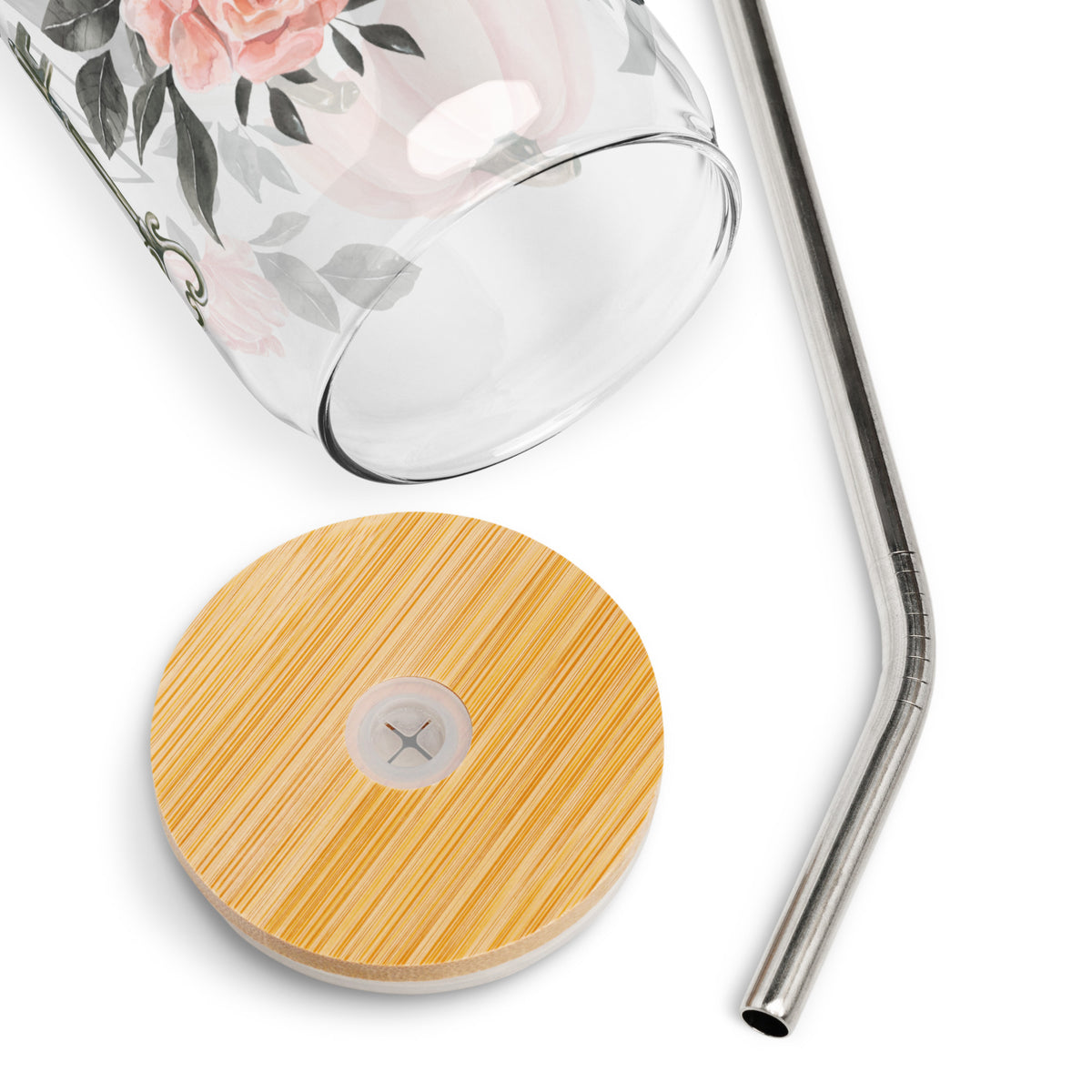 a glass cup with a straw and a wooden coaster next to it