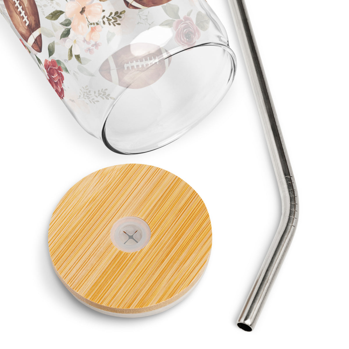 a glass cup with a straw and a wooden coaster next to it