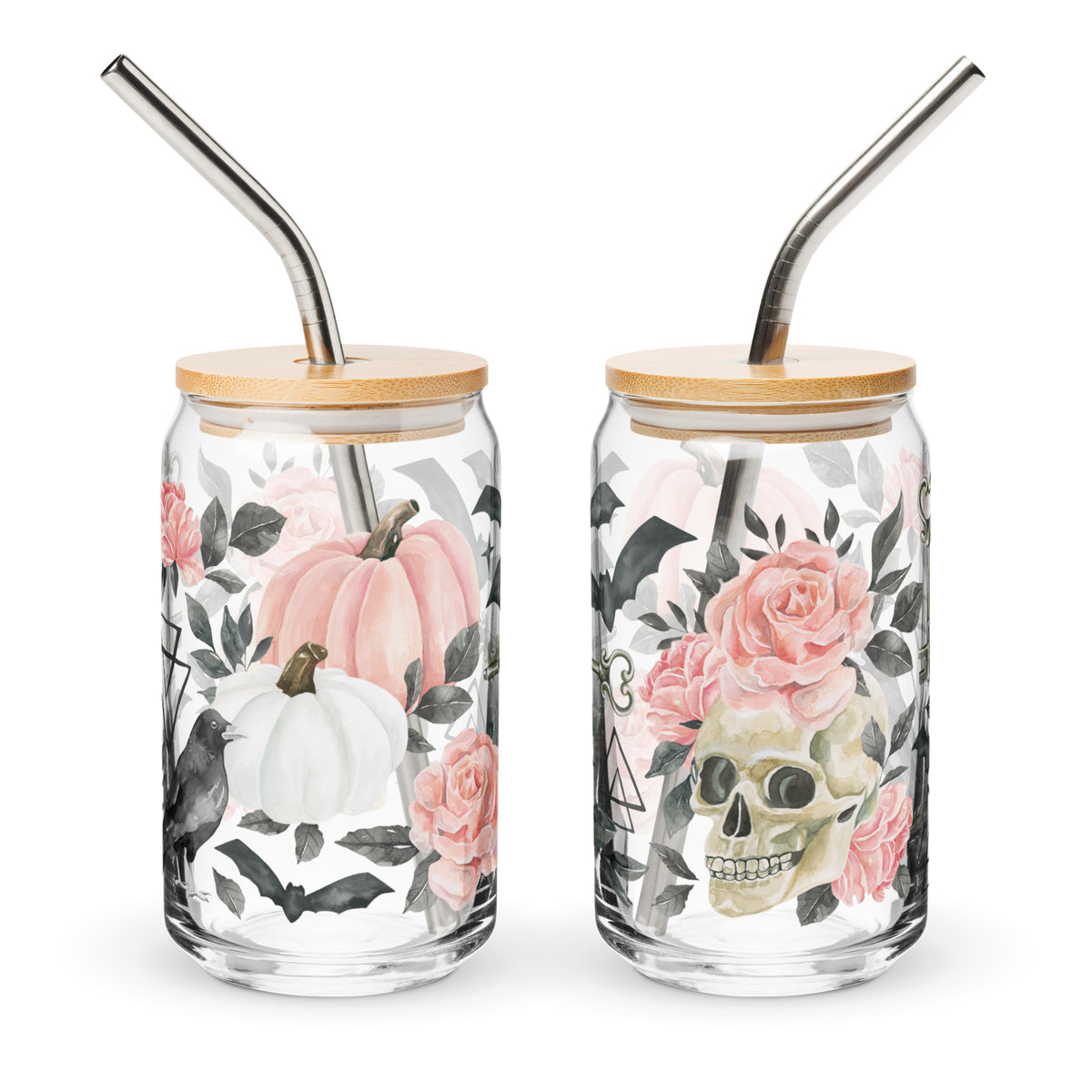 two glass jars with metal straws decorated with flowers and a skull